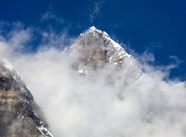 Lhotse üst bulutlar üstünde belgili tanımlık tepe ile