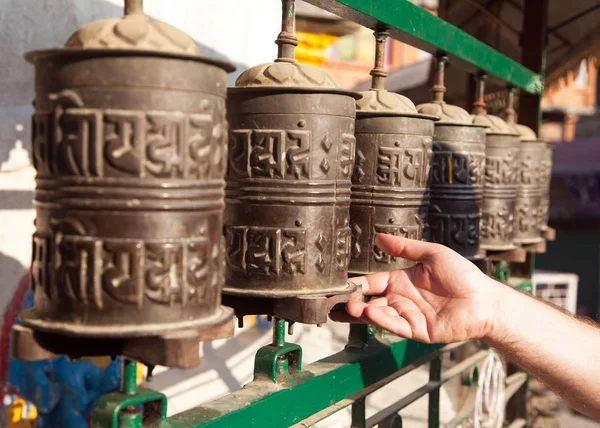 Prayer wheels and a hand — Stock Photo, Image