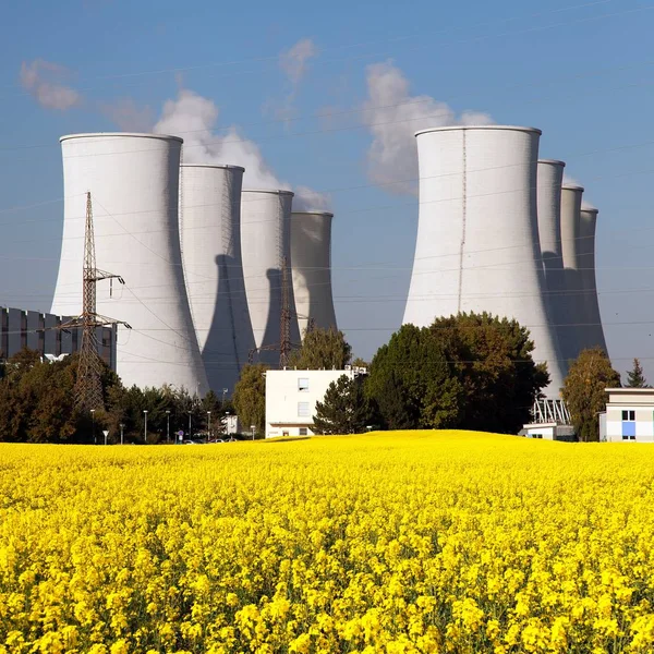 Nuclear power plant and field of rapeseed — Stock Photo, Image