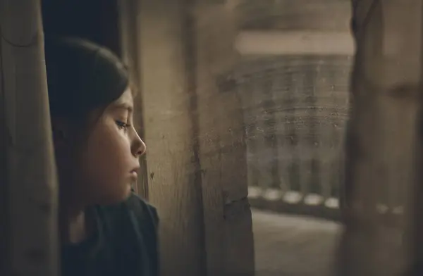 Thoughtful girl looking at window — Stock Photo, Image