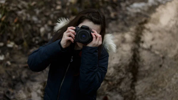 Brunette girl with camera — Stock Photo, Image