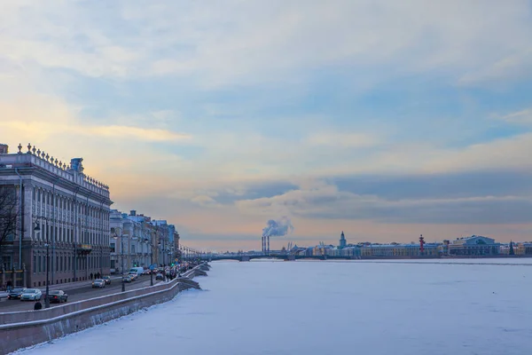 St. Petersburg in winter, beautiful view from Peter and Paul Fortress over the Neva and the Palace Embankment, sunset at the Neva River wearing the ice. — Stock Photo, Image