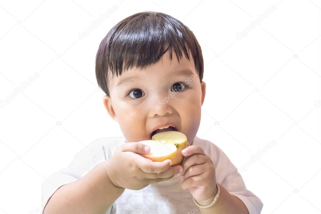 Happy boy enjoy eating apple on white background