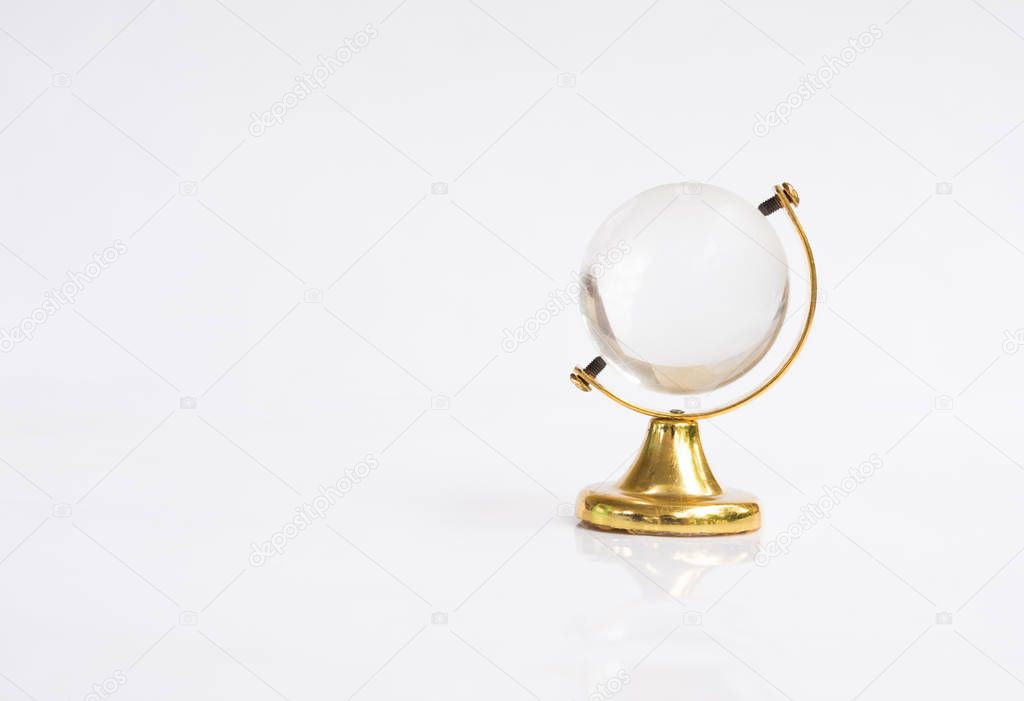 Transparent globe object with gold base on white background