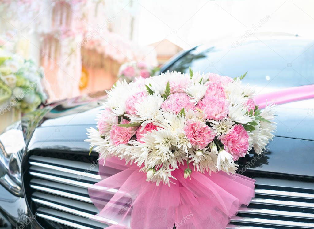 Wedding bouquet flowers on luxury black car