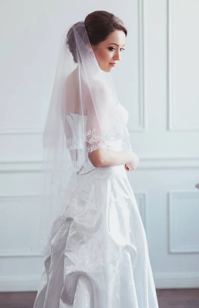 Bela noiva com penteado de casamento de moda - em fundo branco. Retrato de uma jovem. Tiro no estúdio. Menina véu sobre o rosto — Fotografia de Stock