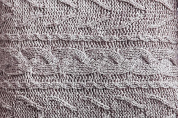 Beautiful gray knitted pattern, knitted scarf close up. Knitted background