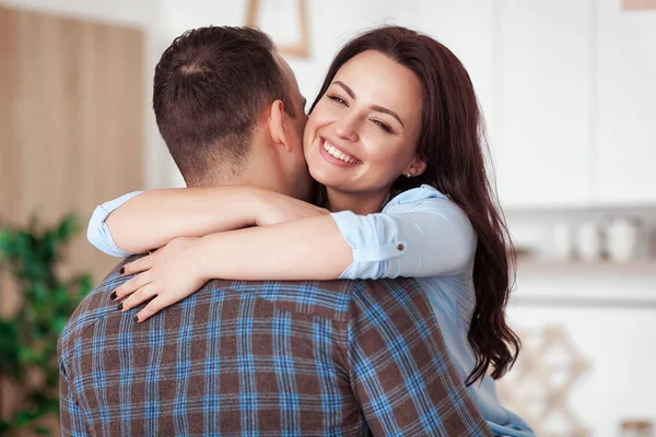 Happy couple hugging in the white loft stile kitchen — Stock Photo, Image