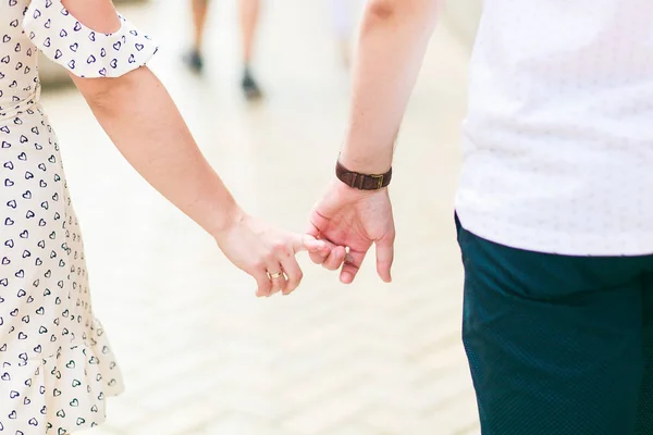 Et par som holder hverandre i hånden på gaten – stockfoto