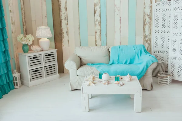 Marine Interior. White sofa and table, seashells, turquoise decor