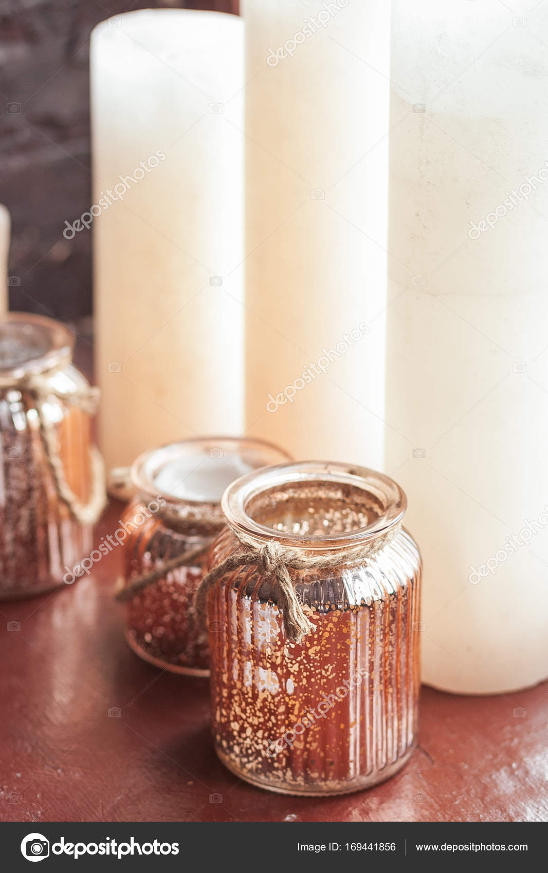 White Christmas candles and a glass jar with rustic twine standing