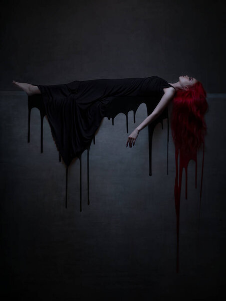 red haired woman in black dress