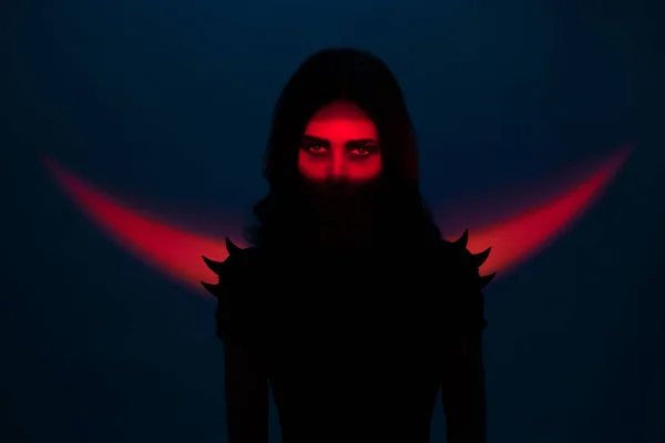 Woman in shadows looking at camera — Stock Photo, Image