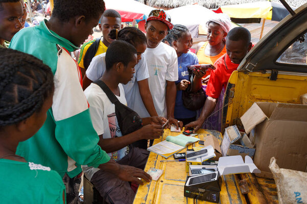 Man sell cellular phones on rural Madagascar marketplace