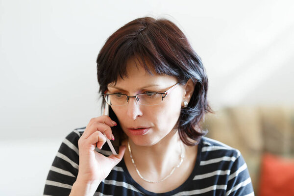 tired middle-aged woman call by phone
