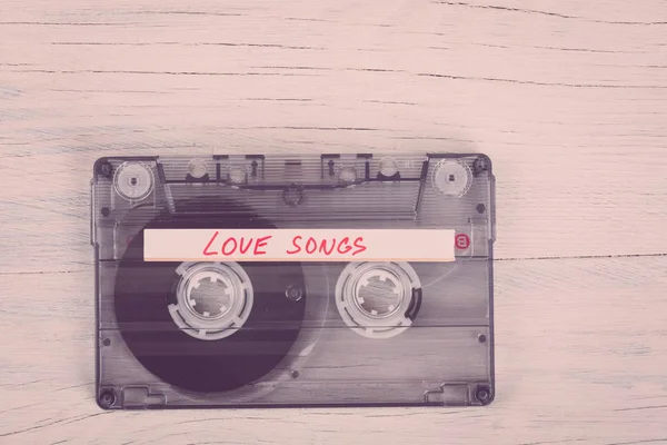 Audio cassette tape op houten achtergrond — Stockfoto