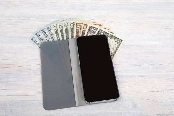 Cellular phone and American dollar money on white — Stock Photo, Image