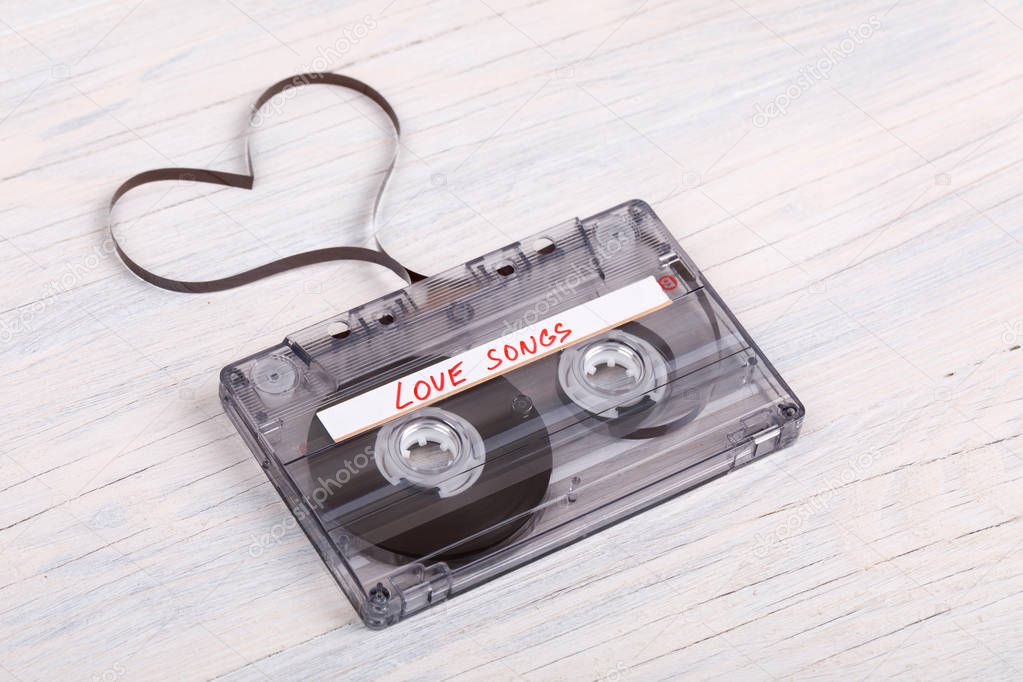 Audio cassette tape on wooden background. audio film shaping hea