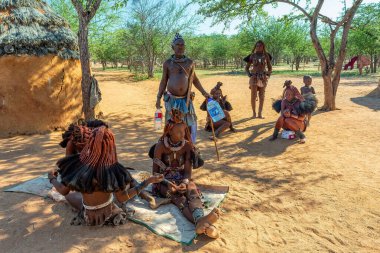 Namibya, Kamanjab, 6 Mayıs 2018, Namibya, Kamanjab yakınlarındaki Himba köyünde çocuklu Himba kabilesinden bir kadın.