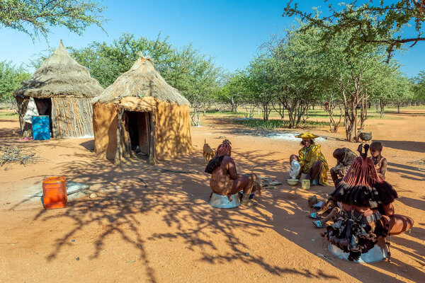 NAMIBIA, KAMANJAB, MAY 6: Himba tribe woman, family with child in the village of Himba people near Kamanjab in northern Namibia, May 6, 2018, Namibia