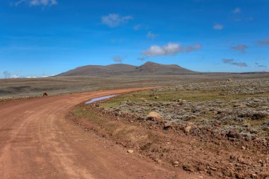 Landscape with road to top of the Ethiopian Bale Mountains National Park. Ethiopia wilderness pure nature. Sunny day with blue sky. clipart