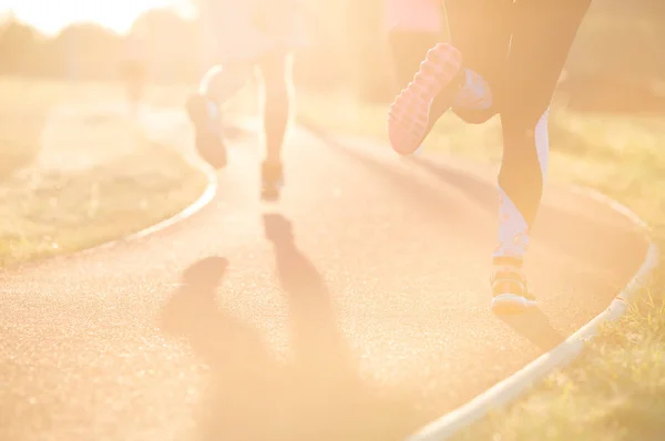 Runner feet running on road closeup on shoe. woman fitness sunri — Stock Photo, Image
