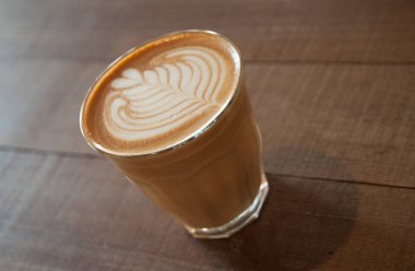 Tablo üzerinde beyaz bir fincan sıcak kahve. kabarcık süt belli değil