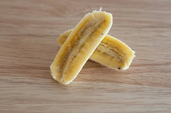 Banana com fatias isoladas em madeira — Fotografia de Stock