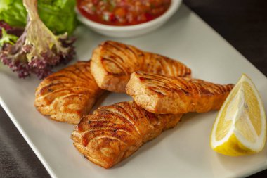 Bu sıcak bir tabak ızgara kırmızı balık ve domates sosu..