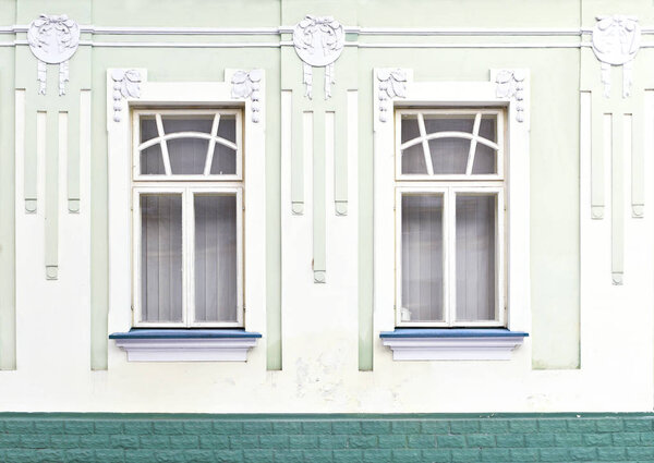 Fragment of the facade of an old building in the background photo. Window. 