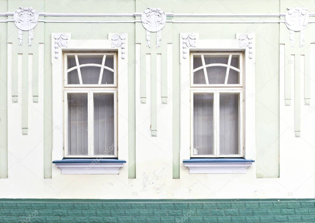 Fragment of the facade of an old building in the background photo. Window. 