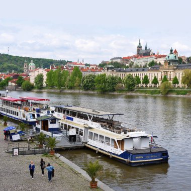 PRAGUE, CZECH REPUBLIC - May 7, 2017: The Vltava River. Berth for tourist river ships near Charles Bridge. clipart