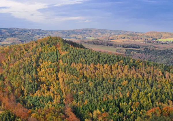 Autumn in Saxon Switzerland with bright forest colors and rocks.