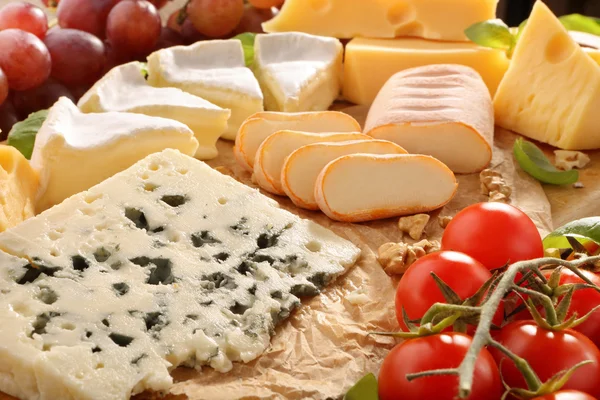 Various types of cheese board composition with tomato — Stock Photo, Image