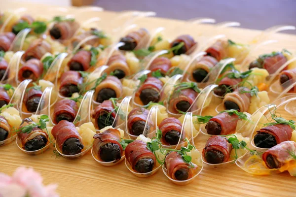 Catering set of pear and plum wrapped in ham Stock Image