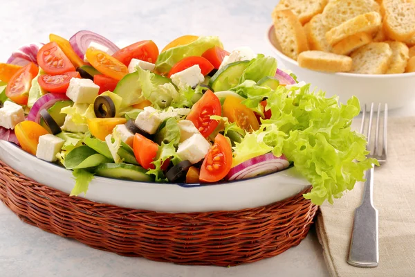 Greek salad with feta cheese black olives and bruscheta — Stock Photo, Image