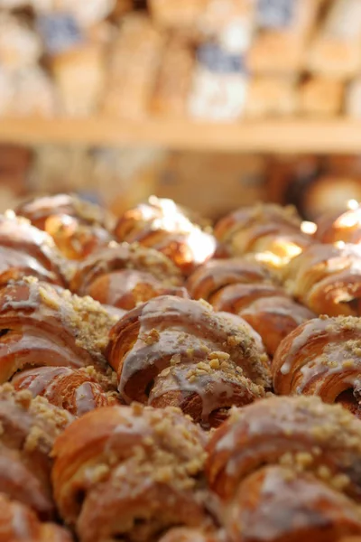 Fresh croissants out of the oven and decorated with icing and wa — Stock Photo, Image