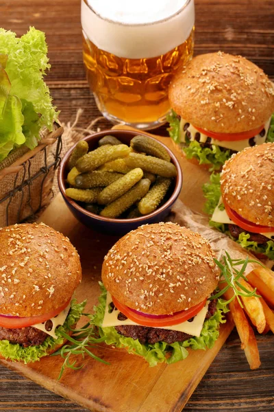 Hamburger s hovězím masem a čerstvou zeleninou na dřevěné poz — Stock fotografie