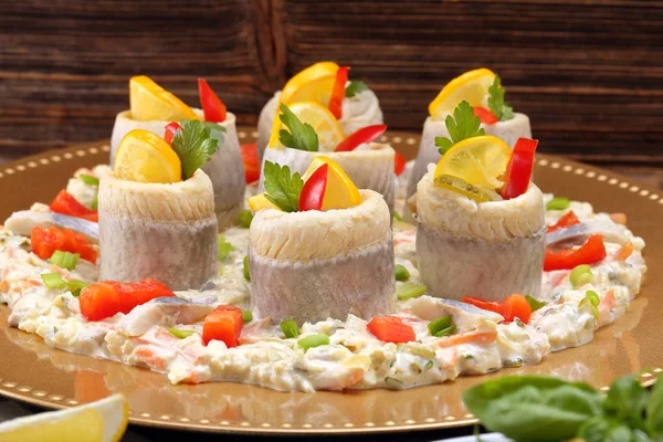 Rolled herrings with fish salad and lemon — Stock Photo, Image
