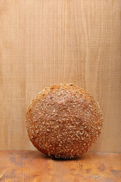 Healthy bread with seeds on wooden background and empty space fo