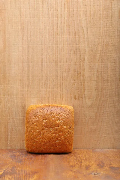 Healthy bread with seeds on wooden background and empty space fo