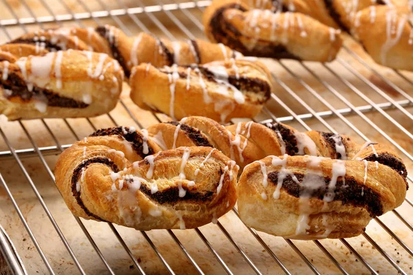 Croissant with poppy seeds and icing — Stock Photo, Image