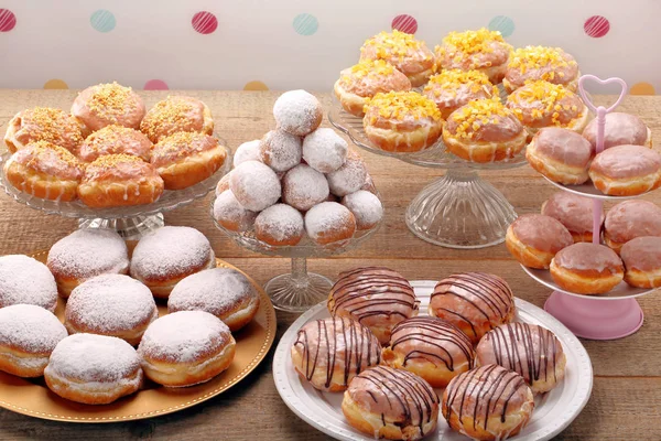 Different types of donuts cakes on wooden table — Stock Photo, Image