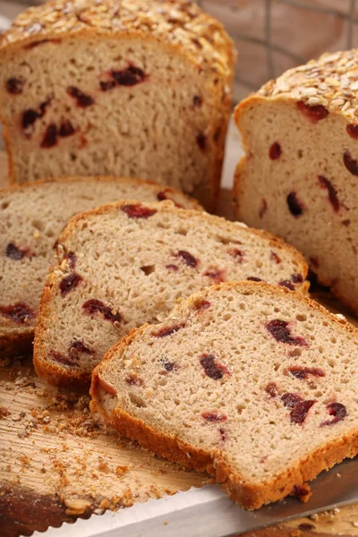 Whole grain bread with cranberry on a wooden board — Stock Photo, Image