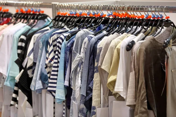 Row of men\'s suits hanging on hanger