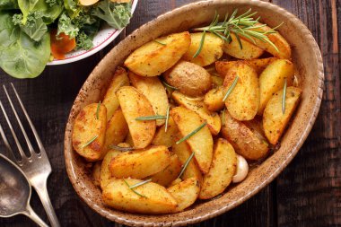 Kavrulmuş patates kahverengi kase taze salata ahşap tablo
