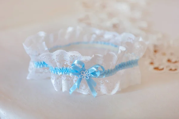 Beautiful white and blue wedding garter — Stock Photo, Image