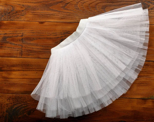 White tutu skirt on wooden background with empty space for text — Stock Photo, Image