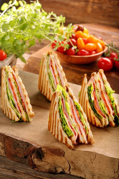 Fresh four sandwiches on wooden background — Stock Photo, Image