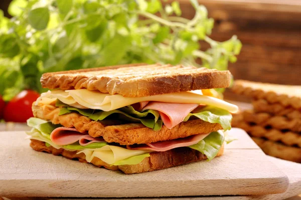 Fresh sandwiches on wooden background — Stock Photo, Image